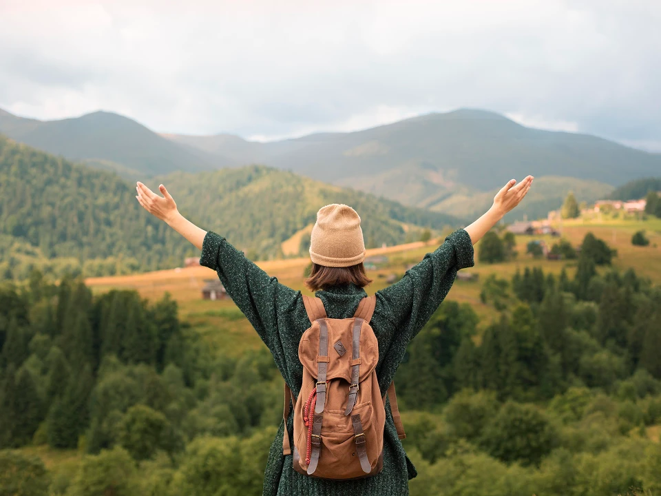 young-female-traveler-enjoying-rural-surroundings 1.webp